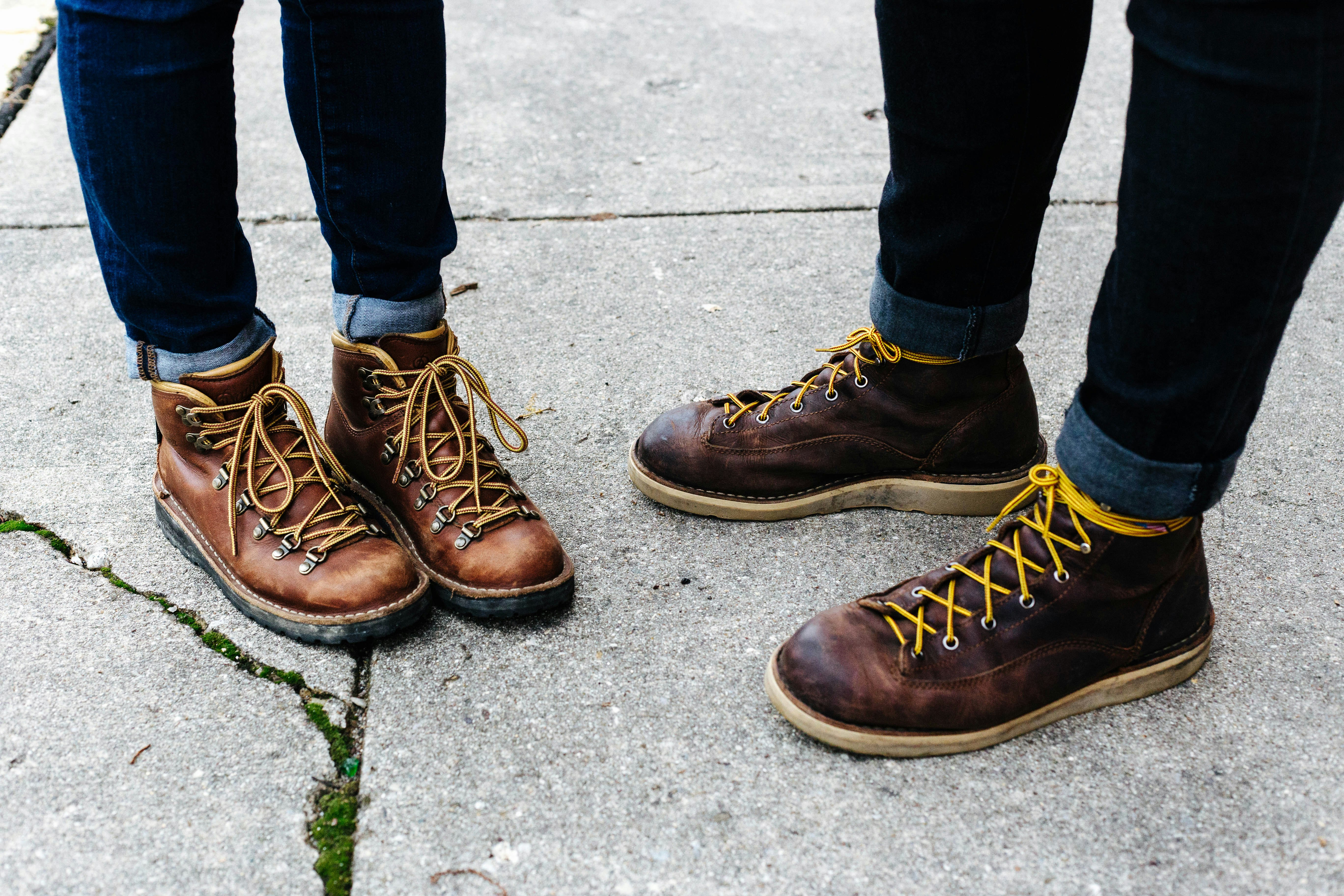 two person wearing brown leather boots